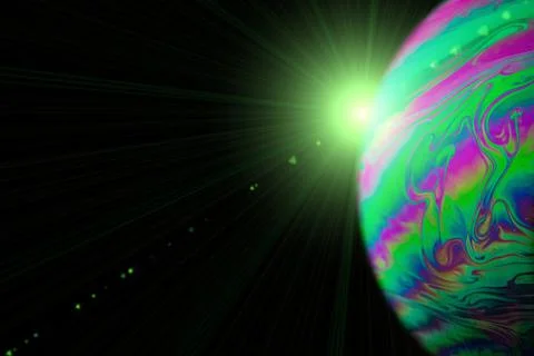 Bubbles macro. Globe planet earth in galaxy universe space with abstract sun on Stock Photos