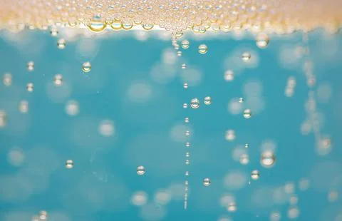 Bubbles macro texture with droplets. Bubbles fizz rising in blue liquid. Bubb Stock Photos