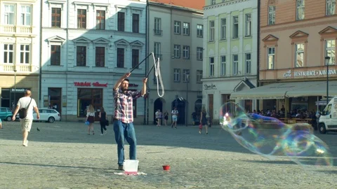 Bubbles making using detergent soap, big bubble, the street arts man Stock Footage 113318211