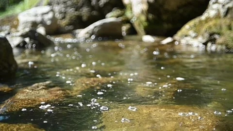 Bubbles on a mountain stream and nice bokeh of stones (slow motion) Stock-Footage 219396436