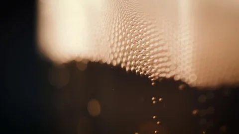 Bubbles movement inside a large glass mug with fresh beer Видео 75660330