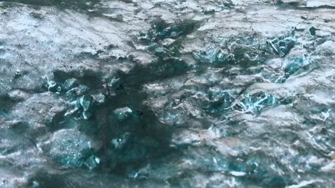 Bubbles moving beneath a translucent layer of ice Stock Footage 336432592