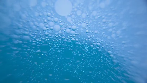 Bubbles moving in blue water Stock Footage 76102933