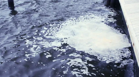 Bubbles on the ocean near the docks Stock Footage 64903753