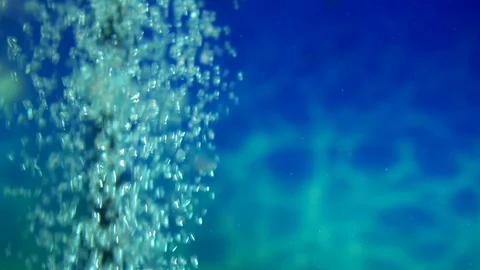 Bubbles oxygen moving line closeup background blue ocean water slowmotion Stock Footage 116793283