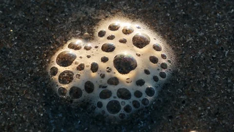 Bubbles pop on the beach Stock Footage 123394732