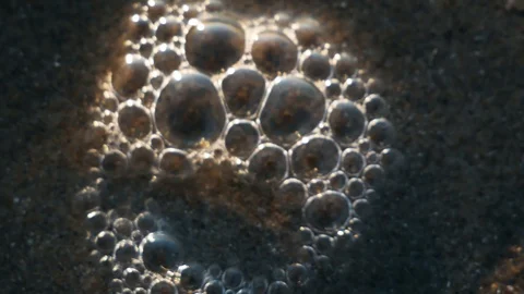 Bubbles pop on the beach Stock Footage 123394796