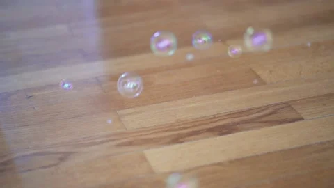 Bubbles pop up from the parquet floor. Concept of support bubble. A group Stock Footage 136272192