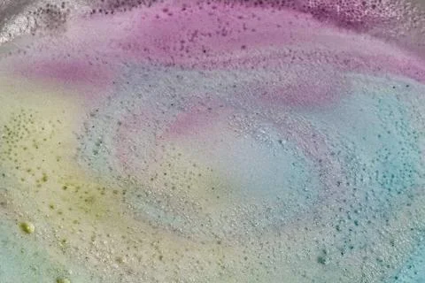 Bubbles produced by bath bombs creates colorful spacy background plate Stock Photos