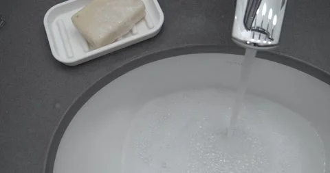 Bubbles Rinsed Down the Bathroom Sink. Stock Footage 158191494