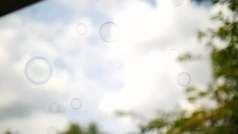 Bubbles rising behind Blue sky and clouds and slow motion Stock Footage 207338710