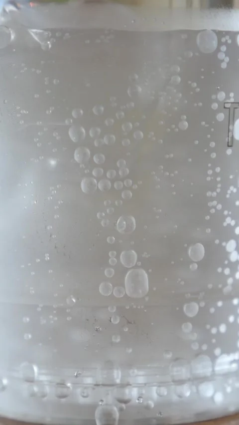 Bubbles rising in clear water with a close-up view Stock Footage 335498640