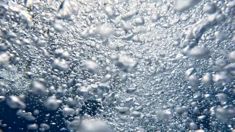 Bubbles rising in clear water from underwater perspective Stock Footage 325620022