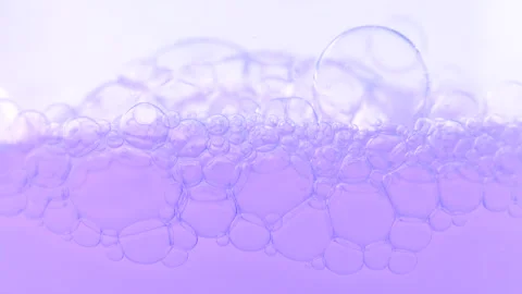 Bubbles rising to the surface. Lavender cosmetics background. Macro shot of.. Stock Footage 275075154