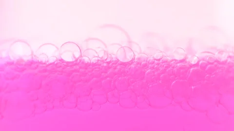 Bubbles rising to the surface. Macro shot of surface level of pink water wi.. Stock Footage 275075451