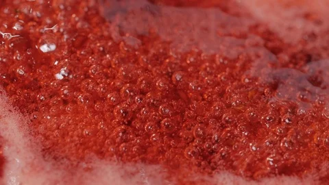 Bubbles rising in thick, red liquid making an abstract background. Stock Footage 87951102