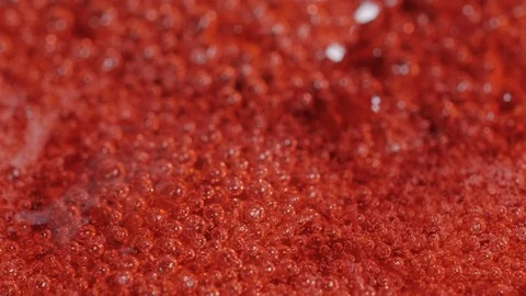Bubbles rising in thick, red liquid making an abstract background. Stock Footage 87951459