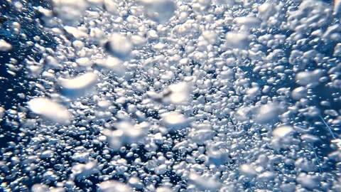 Bubbles rising in water captured from different angles at midday Stock Footage 325619962