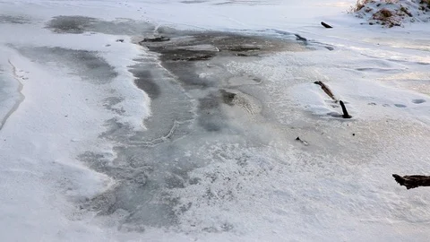 Bubbles from the river below move under the ice in slow motion. Stock Footage 120488829