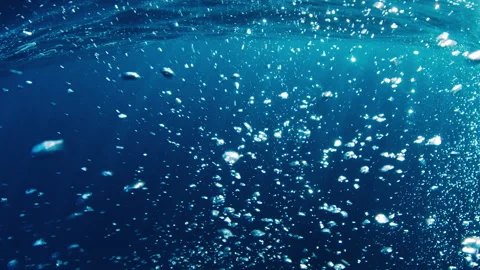 Bubbles in the sea. Camera moves through the cloud of bubbles underwater Stock Footage 247734354