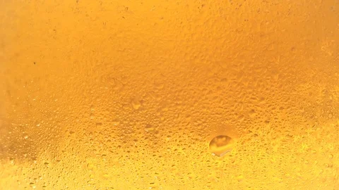 Bubbles slow moving up in glass of cold beer. Stock Footage 88176285