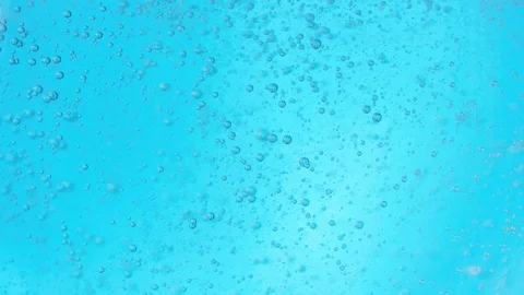 Bubbles slowly rise in bright blue viscous fluid, filmed with red camera 8K Stock Footage 127595052