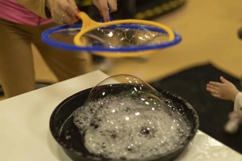 Bubbles. Soap solution for inflatable bubbles. Liquid for entertainment. De.. Stock Photos