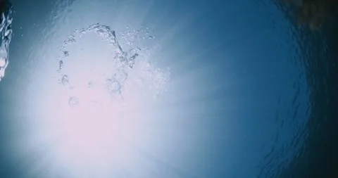 Bubbles with sun rays underwater in transparent blue ocean. Stock Footage 252290967