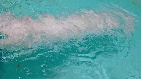 Bubbles on the surface of a swimming pool from a water slide with aqua blue Stock Footage 336341227