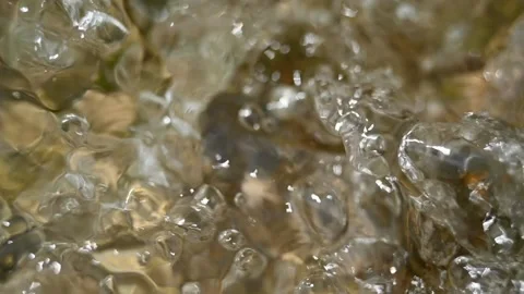 Bubbles swirl fast on the water from a mountain stream (slow motion) 스톡 동영상 219640177