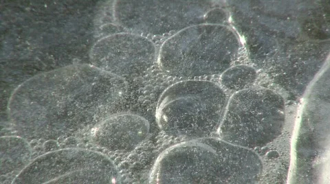Bubbles Under Ice in Stream Stock Footage 119606