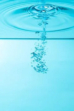 Bubbles under water on blue background Stock Photos