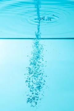 Bubbles under water on blue background Stock Photos