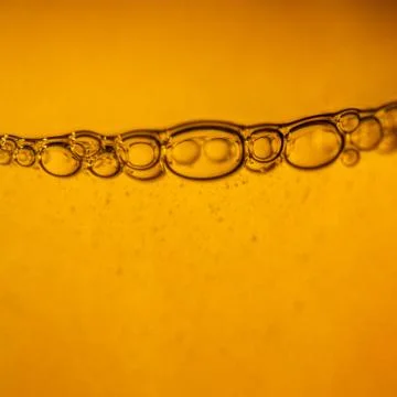 Bubbles under water on yellow Stock Photos