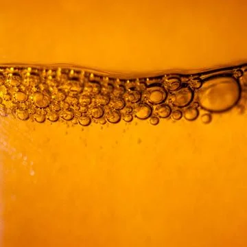 Bubbles under water on yellow Stock Photos