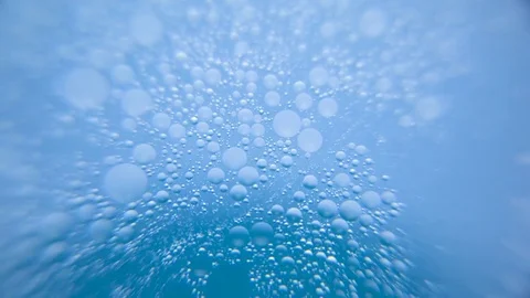 Bubbles in water against blue background Stock Footage 76102798