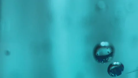 Bubbles of water in a blue plastic bottle rise up Stock Footage 130642837
