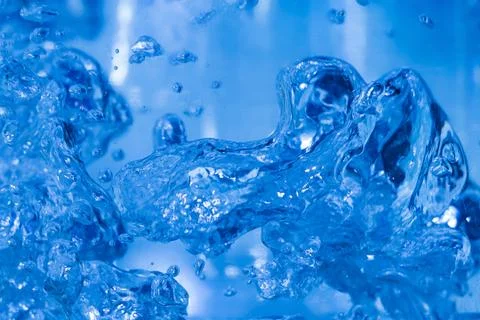 Bubbles in the water close-up. Beautiful splashes of liquid. Stock Photos
