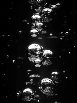 Bubbles water on dark background Stock Photos