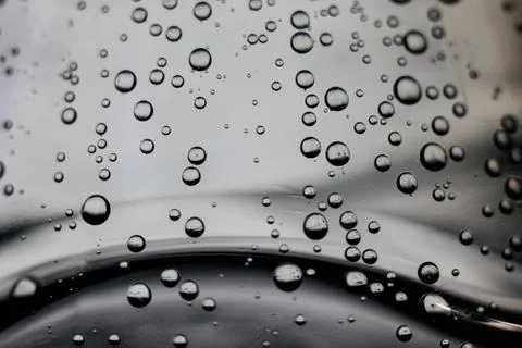 Bubbles in water on a gray background Stock Photos