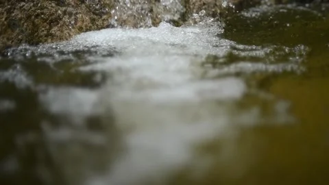 Bubbles on water in a pool  of a mountain river (slow motion, bokeh) Video stock 212751479