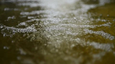 Bubbles on water in a pool  of a mountain river (slow motion, bokeh) Video stock 212751480