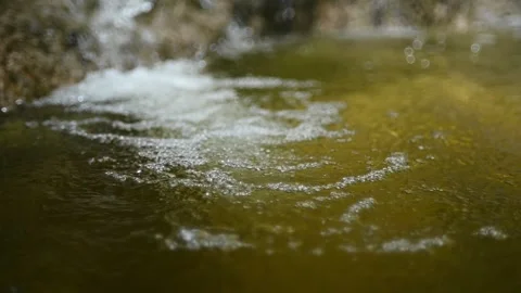 Bubbles on water in a pool  of a mountain river (slow motion, bokeh) Stock-Footage 212751481