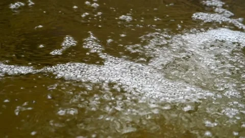 Bubbles on water in a pool  of mountain river (slow motion) Video stock 212752312