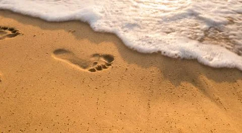 Bubbles waves and foot print on the beach  background.. Stock Photos