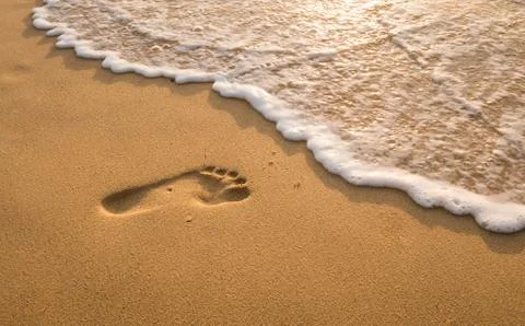 Bubbles waves and foot print on the beach  background.. Stock Photos