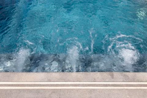 Bubbles from working drain in swimming pool Stock Photos