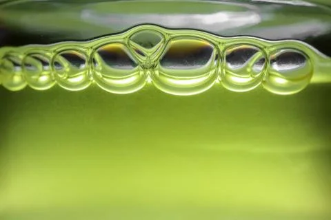 Bubbles in yellow shampoo macro as background Stock-Fotos