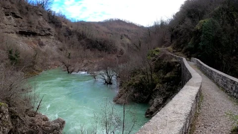 Bubbling azure river from ancient bridge Stock Footage 234645348