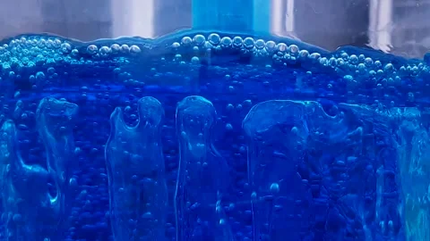 Bubbling blue liquid background video. Stock Footage 183436566
